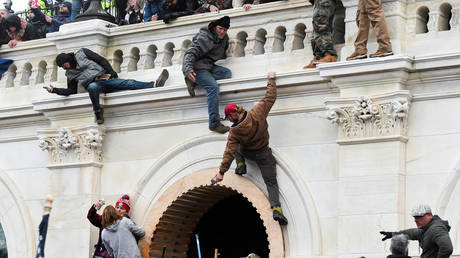 FILE PHOTO: Supporters of Donald Trump climb on walls at the US Capitol during. ©REUTERS / Stephanie Keith