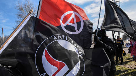 FILE PHOTO: Members of Antifa fly flags during a protest against the Alt-right outside a hotel in Warren, Michigan.