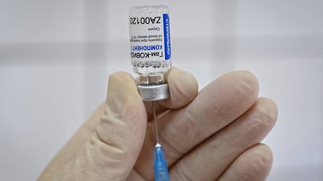 FILE PHOTO: A medical worker fills a syringe with Sputnik V (Gam-COVID-Vac) vaccine as she prepares to vaccinate a Russian Army service member at a clinic in the city of Rostov-On-Don, Russia December 22, 2020.