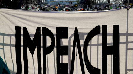A protest sign reading "Impeach" is seen on Black Lives Matter Plaza near the White House one week after rioters stormed the U.S. Capitol