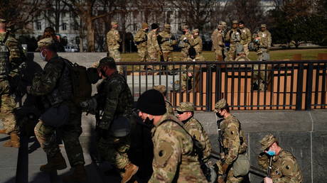 FILE PHOTO: National Guard troops gather outside the US Supreme Court building in the lead-up to President-elect Joe Biden's inauguration, in Washington, DC.
