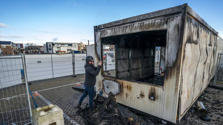 A torched drive-in coronavirus test center is pictured in the port of Urk, the Netherlands on January 24, 2021.