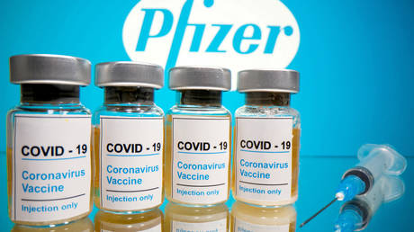 FILE PHOTO: FILE PHOTO: Vials with a sticker reading, "COVID-19 / Coronavirus vaccine / Injection only" and a medical syringe are seen in front of a displayed Pfizer logo in this illustration taken October 31, 2020.