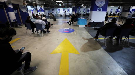 A general view picture shows people waiting to receive a vaccination against the coronavirus disease (COVID-19) at a temporary healthcare maintenance organisation (HMO) centre at an underground parking lot in Givatayim Mall, near Tel Aviv, Israel January 19, 2021