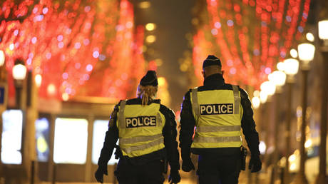 FILE PHOTO: Police officers patrol a street during a curfew in Paris, France, December 2020. © Stefano Rellandini / AFP