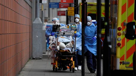 Medical workers move a coronavirus patient in London. (FILE PHOTO)