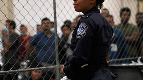 FILE PHOTO: A U.S. Customs and Border Protection agent monitors single-adult male detainees at Border Patrol station in McAllen, Texas, U.S. July 12, 2019.