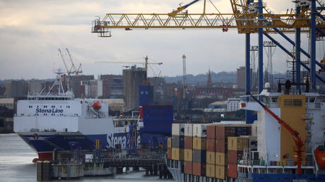 Ferry next to container ship at Port of Belfast, Northern Ireland, January 2, 2021