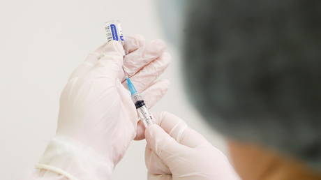 FILE PHOTO: A healthcare worker fills a syringe with a dose of the Sputnik V coronavirus vaccine at a facility in Moscow, Russia.