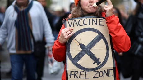 FILE PHOTO: An anti-lockdown protester holding a sign in London, Britain.