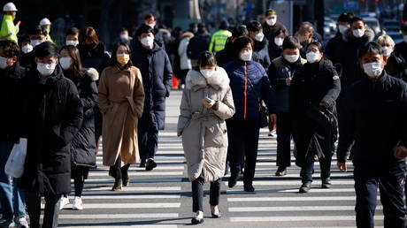 Commuters cross a zebra crossing in Seoul, South Korea on February 3, 2021.