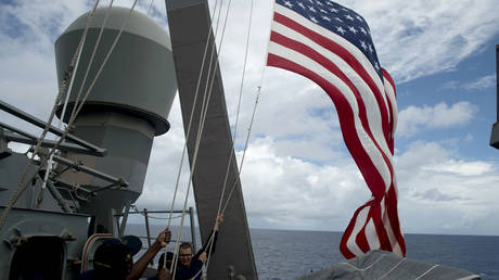 FILE PHOTO: US Navy personnel raise their flag during Cooperation Afloat Readiness and Training (CARAT) Philippines 2014, a U.S.-Philippines military exercise, aboard USS John S. McCain in the South China Sea near waters claimed by China June 28, 2014.