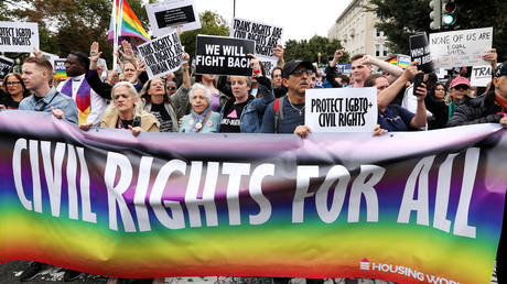 LGBTQ activists and supporters block the street outside the U.S. Supreme Court