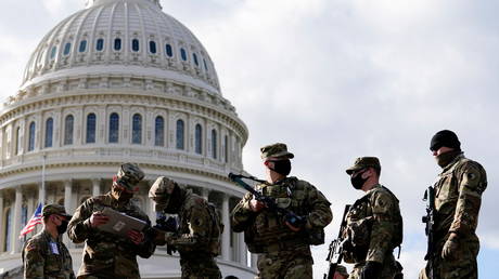 National Guard troops receive guns and ammunition outside the U.S. Capitol building