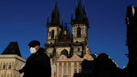 A man wearing a face mask walks across the Old Town Square amid the coronavirus disease (COVID-19) outbreak in Prague, Czech Republic, January 31, 2021.