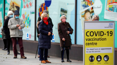 FILE PHOTO: People queue to receive the coronavirus disease (COVID-19) vaccine in Folkestone, Kent, Britain January 28, 2021.