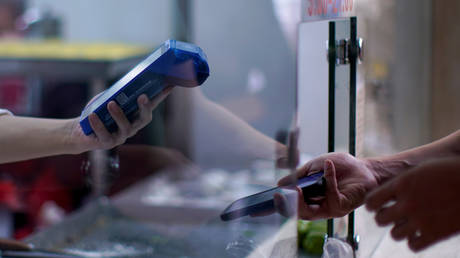 FILE PHOTO. A person gets a scan of a phone's QR code in Shanghai, China. ©REUTERS / Aly Song