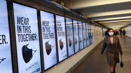 A subway rider passes ads for face masks, in New York City, US, November 14, 2020.