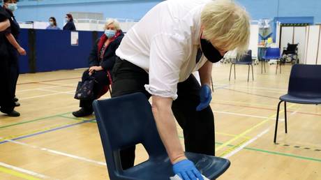Got away with murder? Boris Johnson jokes at Covid vaccine centre as he tries to put on tight gloves &lsquo;like O.J. SIMPSON&rsquo;