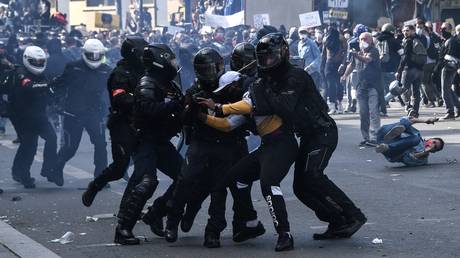 FILE PHOTO: French riot police forces detain a protester during a rally as part of the 'Black Lives Matter' worldwide protests against racism and police brutality, on Place de la Republique in Paris on June 13, 2020