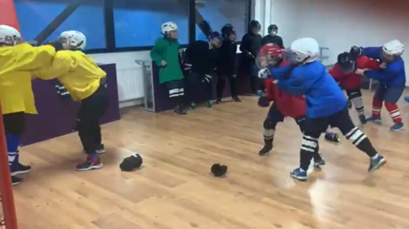 A video screenshot shows Russian youth hockey players being taught to brawl.
