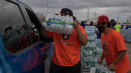 Volunteers give water to residents affectred by unprecedented winter storm in Houston, Texas