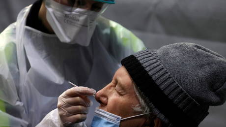 A medical worker administers a nasal swab to a patient at a coronavirus disease (Covid-19) testing center installed inside in the Kursaal concert hall in Dunkirk, France, (FILE PHOTO) © REUTERS/Pascal Rossignol