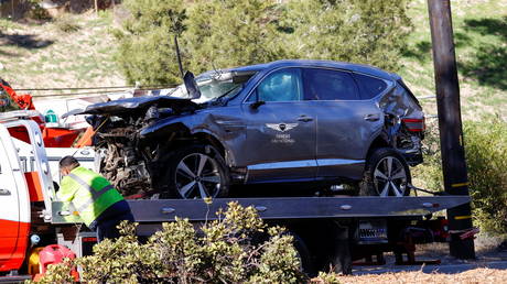 The damaged car driven by golfer Tiger Woods is towed away from the crash scene near Los Angeles, California, February 23, 2021.