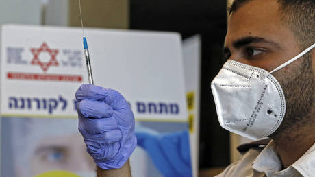 A paramedic with Israel's Magen David Adom medical services prepares a dose of the Pfizer-BioNtech Covid-19 vaccine.