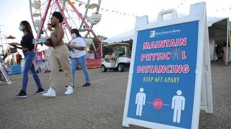 FILE PHOTO: A sign reminding attendees to practice social distancing is seen at the entrance of the Mississippi State Fair, in Jackson, Mississippi, October 7, 2020.