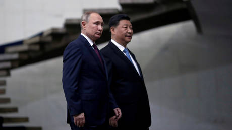 FILE PHOTO: Russia's President Vladimir Putin and China's Xi Jinping walk down the stairs as they arrive for a BRICS summit in Brasilia, Brazil November 14, 2019.