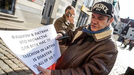 A participant prepares to take part in a rally against government's plans to switch Russian-language schools to Latvian, in Riga, Latvia.
