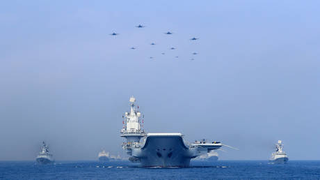 Warships and fighter jets of Chinese People's Liberation Army (PLA) Navy take part in a military display in the South China Sea April 12, 2018 © REUTERS