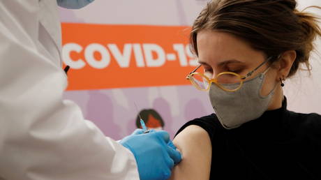 A woman receives a dose of Sputnik V vaccine in Saint Petersburg, Russia, February 24, 2021.