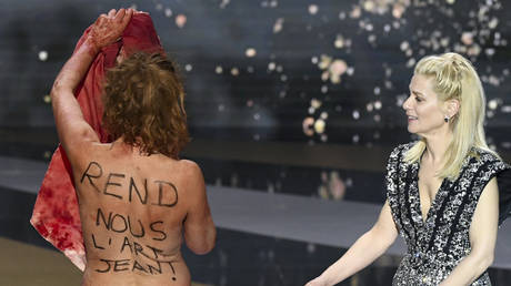 French actress Corinne Masiero (L) stands naked on stage next to French actress and Master of Ceremony Marina Fois during the 46th edition of the Cesar Film Awards ceremony at The Olympia concert venue in Paris on March 12, 2021.