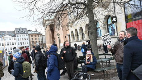 Protesters assemble next to the Copenhagen City Court building in Denmark on March 12, 2021.
