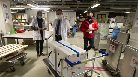 FILE PHOTO: Medical staff receive part of a Pfizer-BioNTech Covid-19 vaccine shipment at the UZ Leuven hospital in Leuven, Belgium on December 26, 2020 © AP/Nicolas Maeterlinck