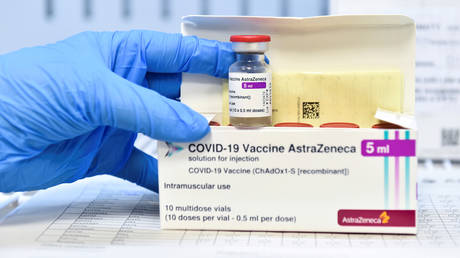 FILE PHOTO: A healthcare worker shows a vial and a box of the AstraZeneca coronavirus disease (COVID-19) vaccine, as vaccinations resume after a brief pause in their use over concern for possible connection to blood clots, in Turin, Italy, March 19, 2021.