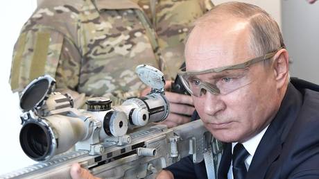 Russian President Vladimir Putin is shooting from a Chukavin sniper rifle (SVCh 380) at Kalashnikov Concern shooting club at the military patriotic park Patriot.