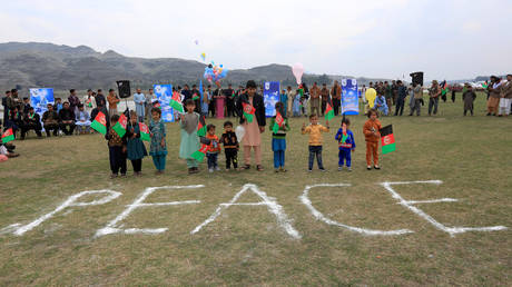 Too soon: Afghan children in Jalalabad, celebrate the US-Taliban peace agreement, February 28, 2020 file photo.