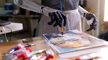 Humanoid robot Sophia, developed by Hanson Robotics, draws on a piece of paper before auctioning her own non-fungible token (NFT) artwork, in Hong Kong, China March 16, 2021. Picture taken March 16, 2021.