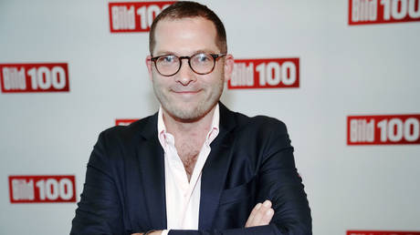 Scandal-hit editor of German tabloid Bild back at work after being cleared in sex probe, will share leadership with female chief