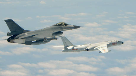 FILE PHOTO. Taiwan Air Force F-16 fighter aircraft (L) flying alongside a Chinese People's Liberation Army Air Force H-6K bomber, May 11, 2018