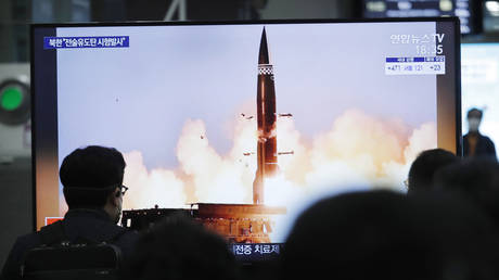 People watch a TV showing an image of North Korea's new guided missile during a news program at the Suseo Railway Station in Seoul, South Korea, Friday.