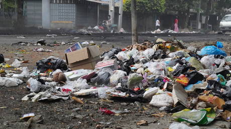 Residents use trash to block streets as a form of protest in Thaketa township, Yangon, Myanmar, in this image obtained by Reuters on March 30, 2021.