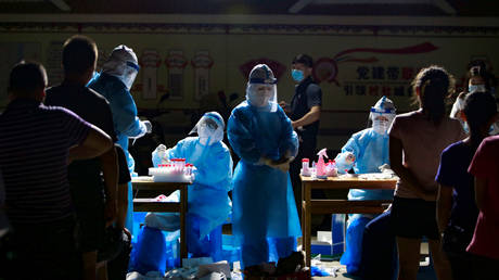 FILE PHOTO. Medical workers in protective suits pictured in the city of Ruili, China.