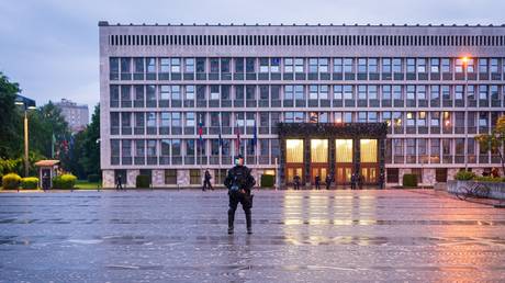 A police officer stands in front of the Slovenian National Assembly building in Ljubljana on May 15, 2020