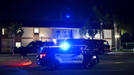 Police officers stand outside a building were multiple people were killed in a shooting in Orange, California on March 31, 2021