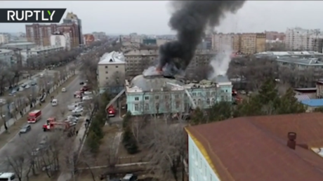 Not feeling the heat: Russian surgeons carry on with life-saving open-heart operation despite FIRE forcing evacuation of building