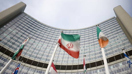 The Iranian flag waves in front of the International Atomic Energy Agency (IAEA) headquarters in Vienna, Austria.